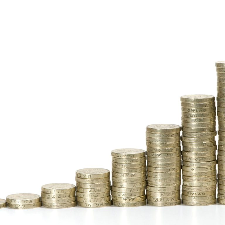 Stacks of coins arranged in ascending order representing growth in savings.