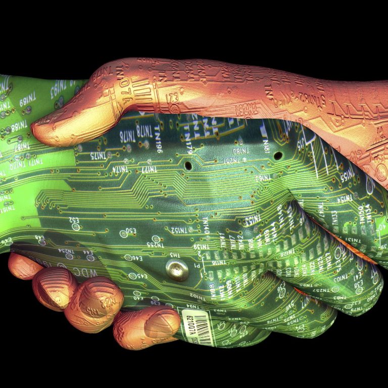 A human hand and a robotic hand shaking, with circuit patterns on the robotic hand.